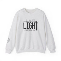 A unisex heavy blend crewneck sweatshirt, the Be the Light Crew, offers comfort with ribbed knit collar and durable double-needle stitching. Made from 50% cotton and 50% polyester, ideal for colder months. Ethically grown US cotton.