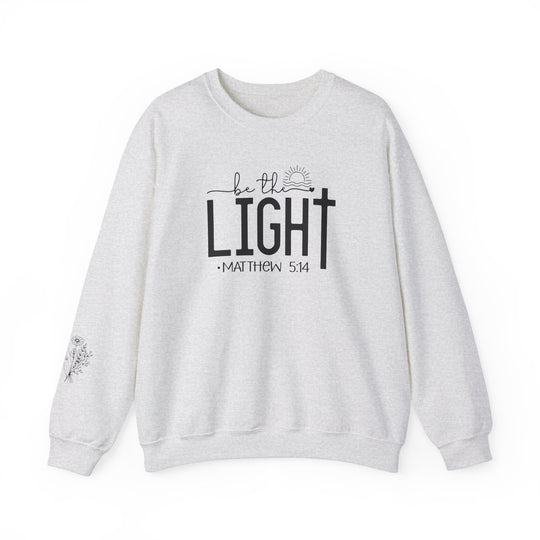 A unisex heavy blend crewneck sweatshirt, the Be the Light Crew, offers comfort with ribbed knit collar and durable double-needle stitching. Made from 50% cotton and 50% polyester, ideal for colder months. Ethically grown US cotton.