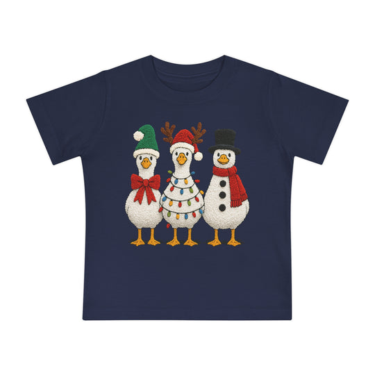 Christmas Geese Baby Tee featuring three cartoon geese in festive attire on a navy-blue background, designed for infants, made from soft, shrink-resistant cotton.