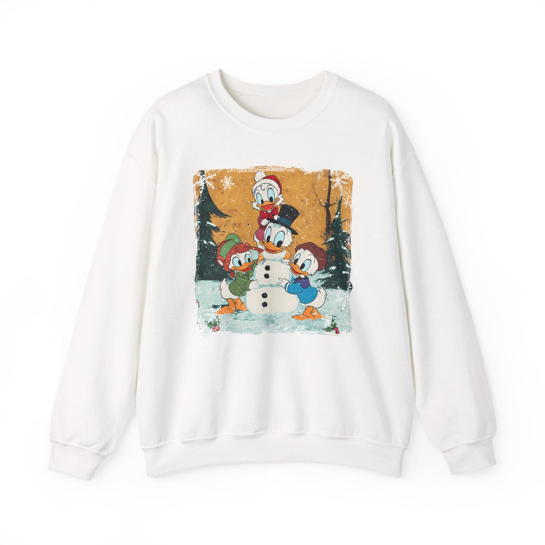Cream sweatshirt with vintage winter scene of Donald Duck and nephews building a snowman. Cozy, durable fabric with ethical production, perfect for colder months.