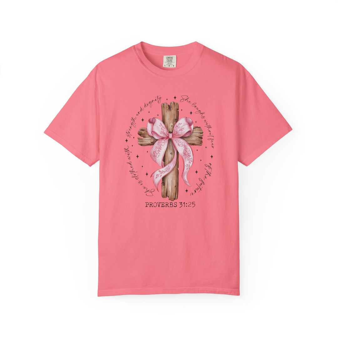 Proverbs 31:25 Tee: Pink short-sleeve T-shirt with rustic wooden cross, floral ribbon, and scripture verse encircling the design, emphasizing strength and dignity.