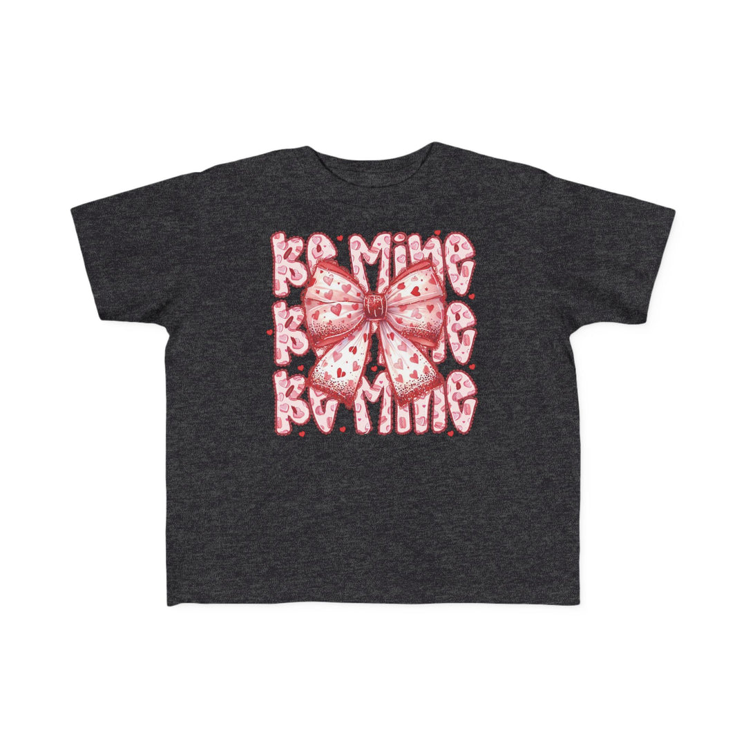 Be Mine Toddler Tee with a pink-and-red heart-patterned bow and Be Mine text, designed for softness and comfort, perfect for Valentine's Day.