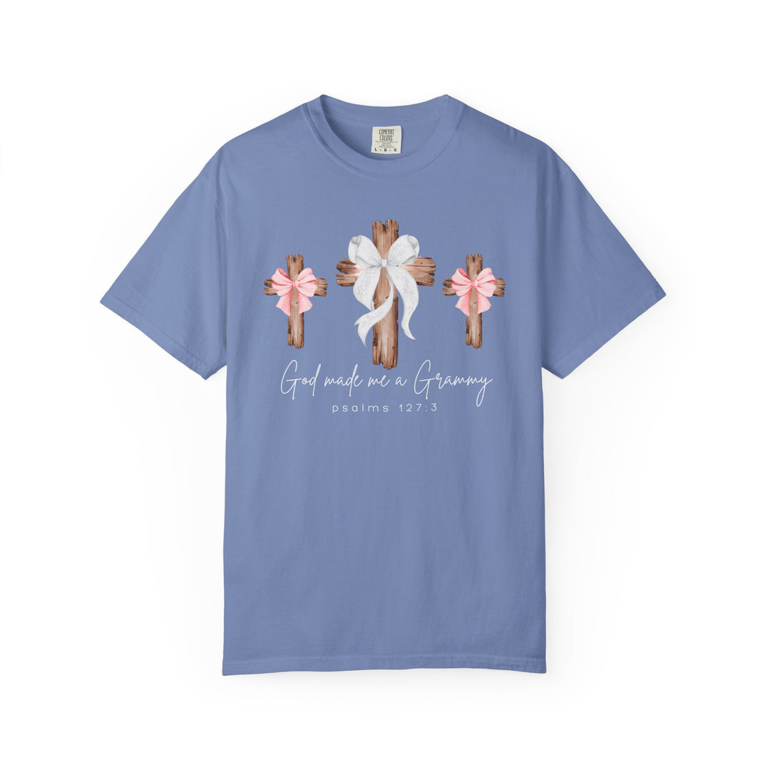 Light-blue 'God Made Me a Grammy' tee with rustic cross design and Psalms 127:3, offering relaxed fit and durability from Faith Family Designs.