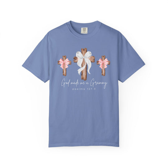 Light-blue 'God Made Me a Grammy' tee with rustic cross design and Psalms 127:3, offering relaxed fit and durability from Faith Family Designs.