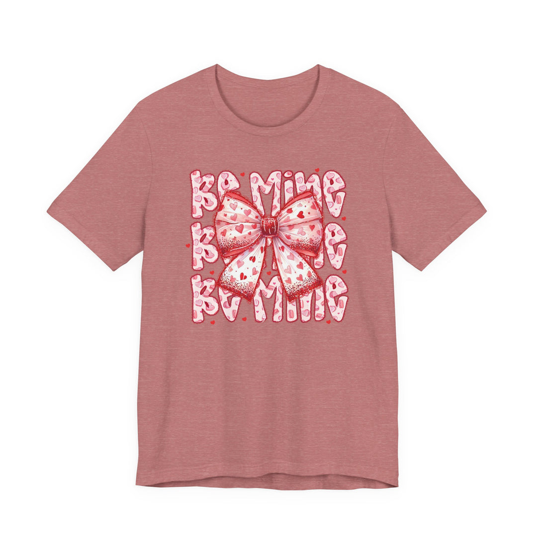 Heather-rose Be Mine Tee with a hand-drawn bow and BAMING text, perfect for Valentine's Day. Soft cotton, unisex fit, from Faith Family Designs.
