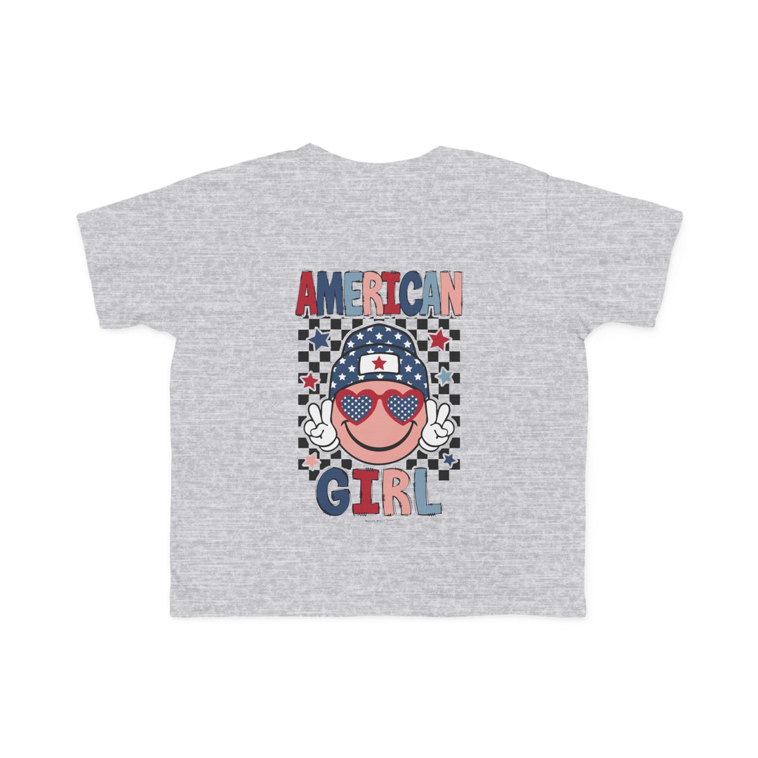 American Girl Toddler Tee featuring a grey t-shirt with a cartoon face and sunglasses, perfect for sensitive skin. Made of 100% combed ringspun cotton, light fabric, tear-away label, and a classic fit. Sizes: 2T, 3T, 4T, 5-6T.
