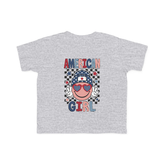 American Girl Toddler Tee featuring a grey t-shirt with a cartoon face and sunglasses, perfect for sensitive skin. Made of 100% combed ringspun cotton, light fabric, tear-away label, and a classic fit. Sizes: 2T, 3T, 4T, 5-6T.