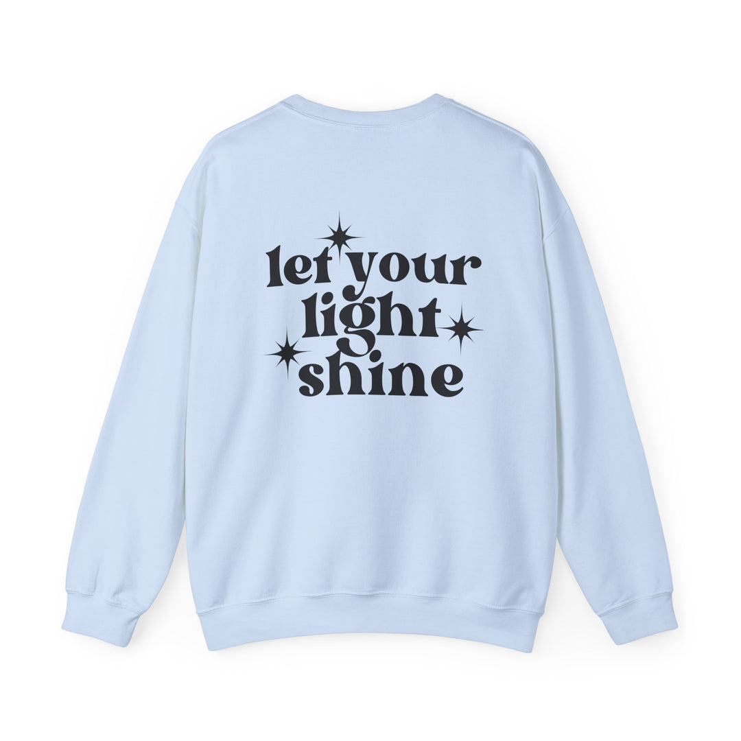 A white crewneck sweatshirt with black text, featuring the Let Your Light Shine Crew design. Unisex, heavy blend fabric for comfort, ribbed knit collar, and no itchy side seams. Sizes range from S to 5XL.