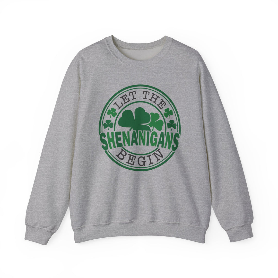 Grey sweatshirt featuring 'Let the Shenanigans Begin Day Crew' in green text, ideal for comfort and style with a ribbed collar and loose fit.