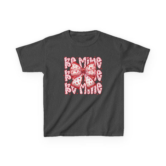 Be Mine Kids Tee features a charcoal-gray design with a pink-and-red heart bow and BE MINE in a heart-patterned, bubbly typeface, perfect for everyday wear.