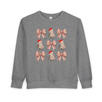 Cookies and Bows Toddler Crew: Heather-gray sweatshirt with festive bow and Christmas tree motifs, crafted for comfort with a durable cotton-polyester blend. Ideal for toddlers.