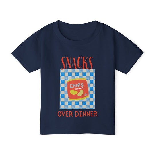 Heavy Cotton™ Toddler T-shirt features a Chips Classic graphic, showcasing a vibrant chip bag with SNACKS OVER DINNER text, perfect for playful style.