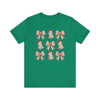 Cookies and Bows Tee: Green T-shirt featuring a 3x3 grid of festive motifs, including decorative bows and Santa-hat-topped trees, offering a playful holiday design.
