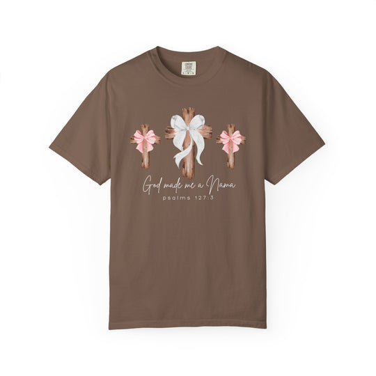 Comfort Colors brown tee features three rustic crosses, center with white ribbon, side crosses with pink bows, text 'God made me a Nana' and 'Psalms 127:3'.