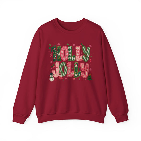 Red Holly Jolly Crew sweatshirt features festive knitted-style lettering with holiday motifs including snowflakes, holly, Santas, a snowman, and a Christmas tree.