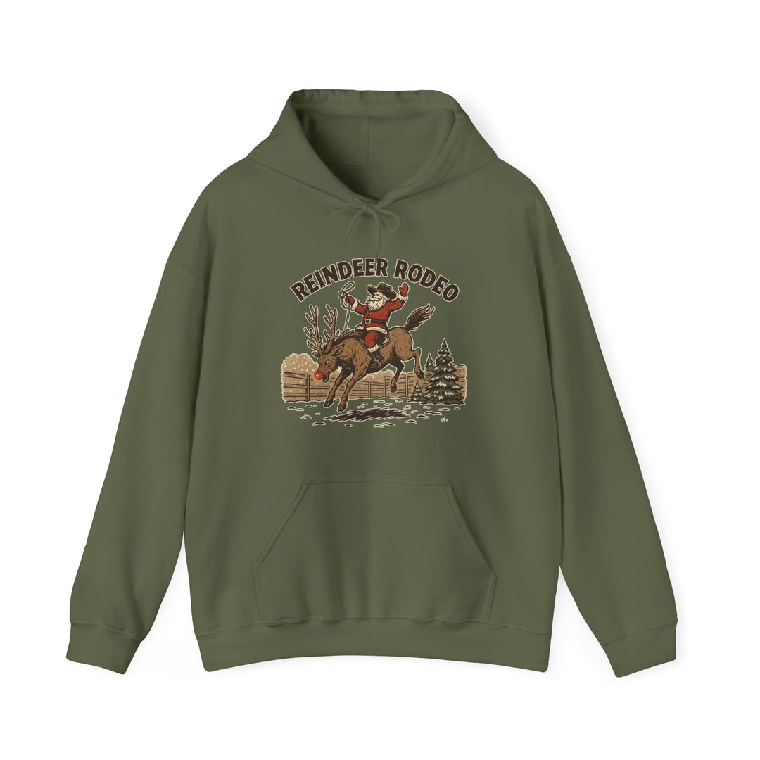 Reindeer Rodeo Hoodie featuring Santa riding a reindeer, olive-green, with drawstring hood and kangaroo pocket. Cozy, vintage-style design perfect for cold days.