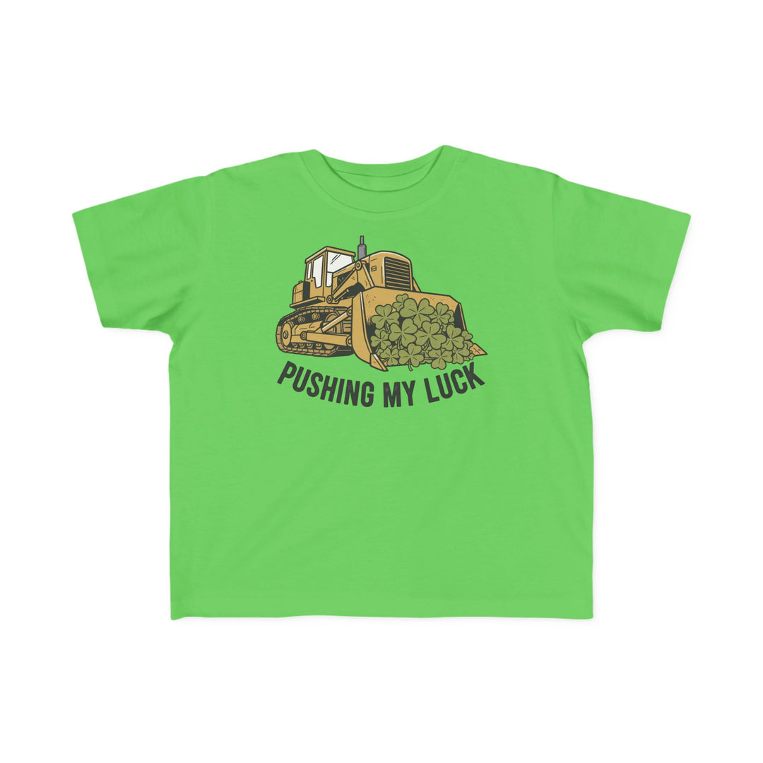 Pushing My Luck Toddler Tee: A bright green shirt with a yellow bulldozer and clovers graphic, ideal for toddlers, providing softness and durability for playful adventures.