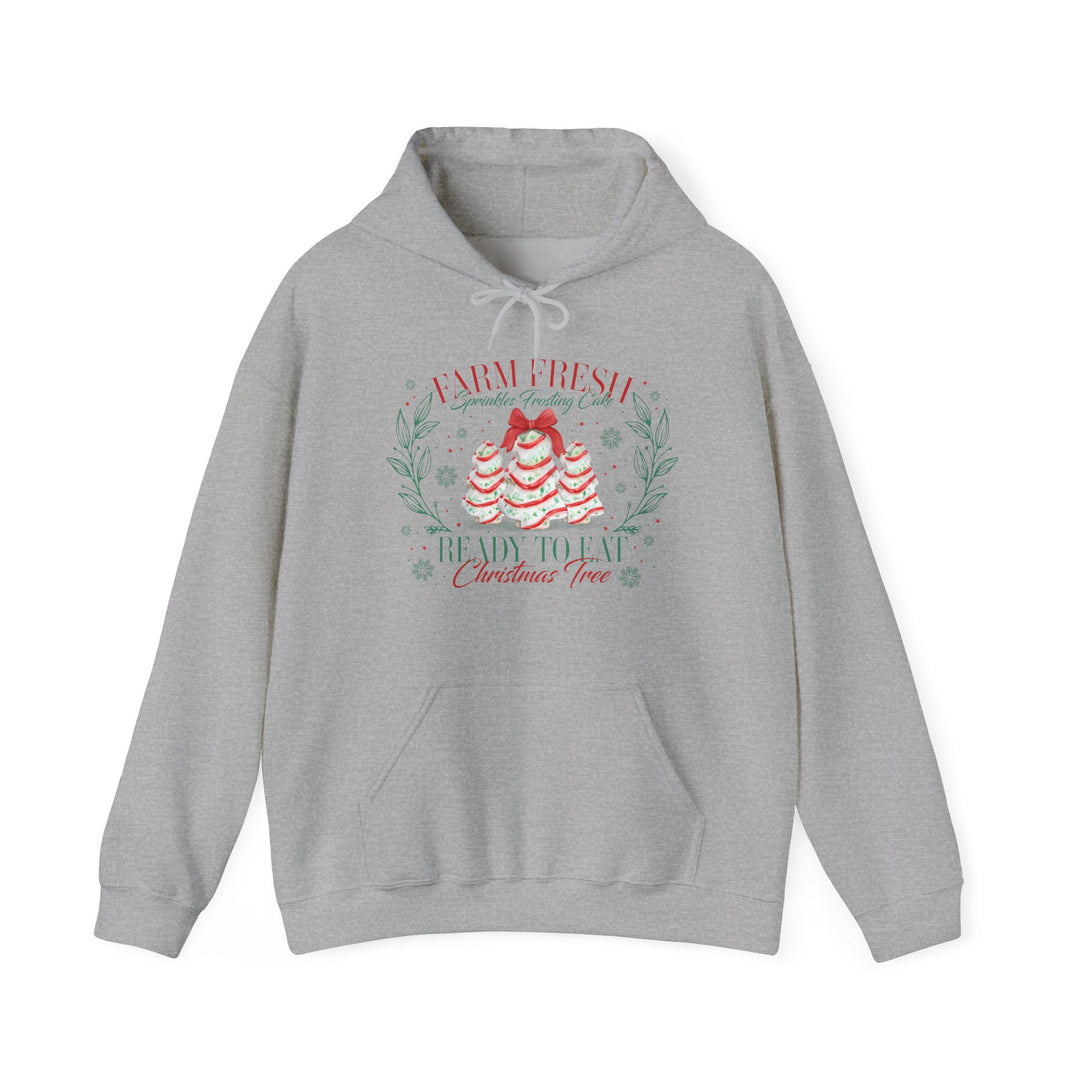 Light-gray hoodie features festive cake trees graphic with Farm Fresh Sprinkles Frosting Cake text, kangaroo pocket, and drawstring hood. Cozy, unisex fit.