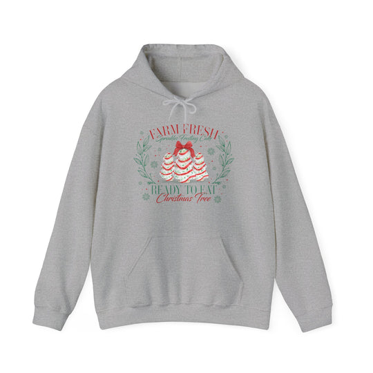 Light-gray hoodie features festive cake trees graphic with Farm Fresh Sprinkles Frosting Cake text, kangaroo pocket, and drawstring hood. Cozy, unisex fit.