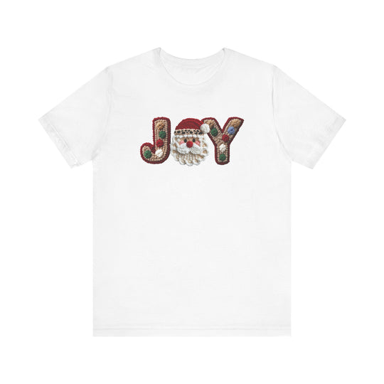 Joy Tee: A white crew-neck featuring a festive “JOY” design with knit-style “J” and “Y” and a Santa Claus face as the “O”.