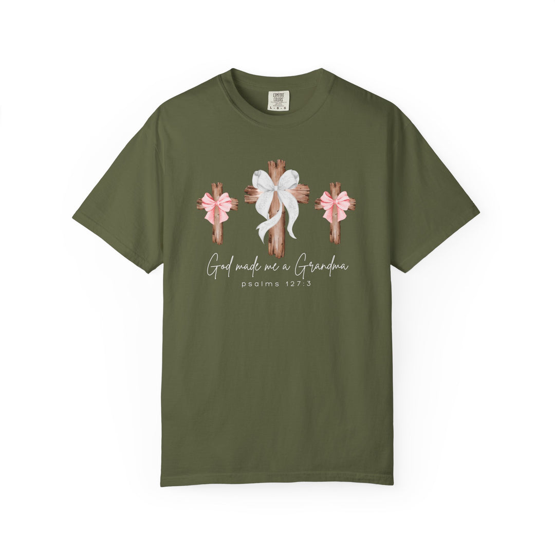 Olive-green tee with rustic wooden crosses and 'God Made Me a Grandma' text, featuring a relaxed fit and durable stitching.