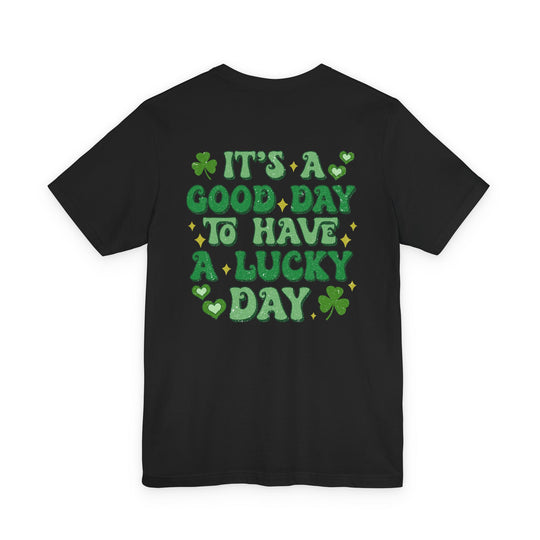 Back of the Good Day Lucky Day Tee featuring a playful graphic with green shamrocks, hearts, and retro text, ideal for casual, trendy wear.