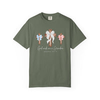 Olive-green T-shirt featuring three rustic wooden crosses with bows, and the text “God made me a Grandma” and “Psalms 127:3” below.