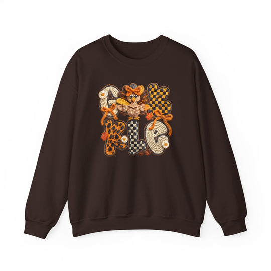 Dark-brown Gobble Crew sweatshirt with crochet-style applique, featuring GOBBLE in patchwork letters and a stylized turkey, ideal for cozy autumn wear.