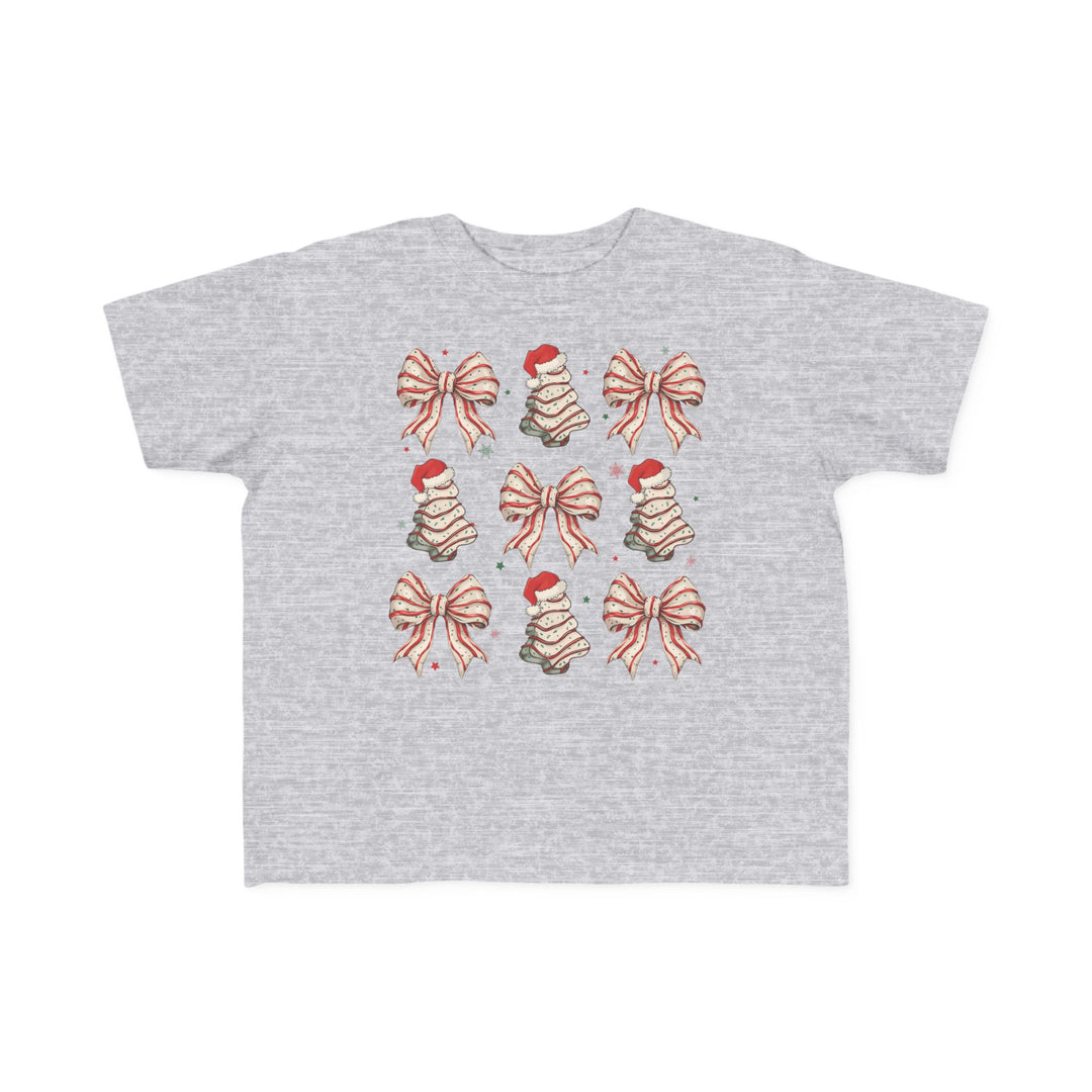 Cookies and Bows Toddler Tee with festive icons of bows and Christmas trees, perfect softness for toddlers, durable print, available in toddler sizes.