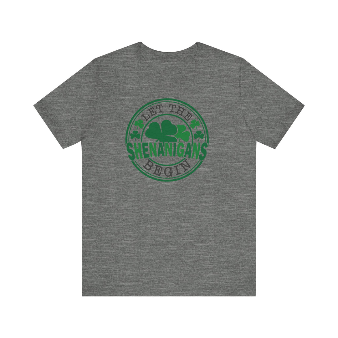 Back of grey 'Let The Shenanigans Begin' tee featuring a green and black circular clover logo, designed for comfort and style.