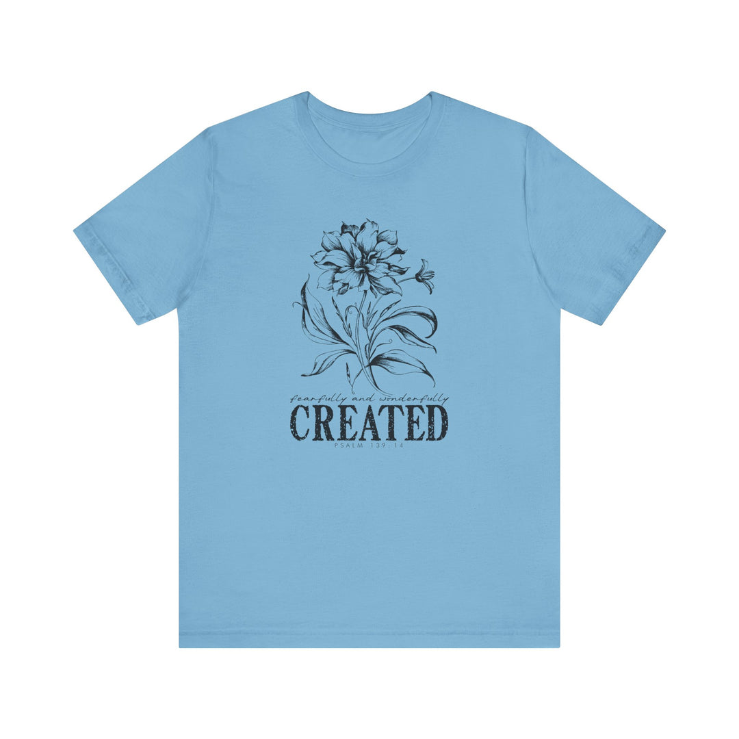 Unisex jersey short sleeve tee, titled Created Tee, with ribbed knit collar and tapered shoulders, offering a comfortable fit. Made of soft Airlume cotton for casual wear.