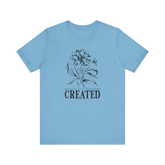 Unisex jersey short sleeve tee, titled Created Tee, with ribbed knit collar and tapered shoulders, offering a comfortable fit. Made of soft Airlume cotton for casual wear.
