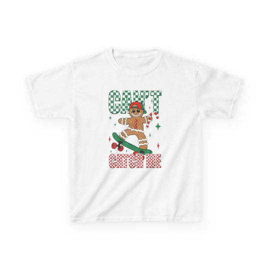 Can't Catch Me Kids Tee features a gingerbread figure on a skateboard with a candy cane, surrounded by festive checkered text and sparkle accents.