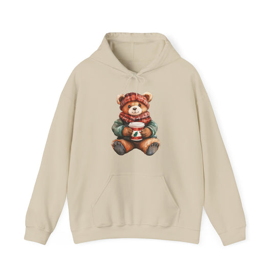 Old Money Bear Hoodie with a teddy bear graphic in winter attire, featuring a red-plaid hat and scarf, holding a festive cup. Cozy cotton-polyester blend.