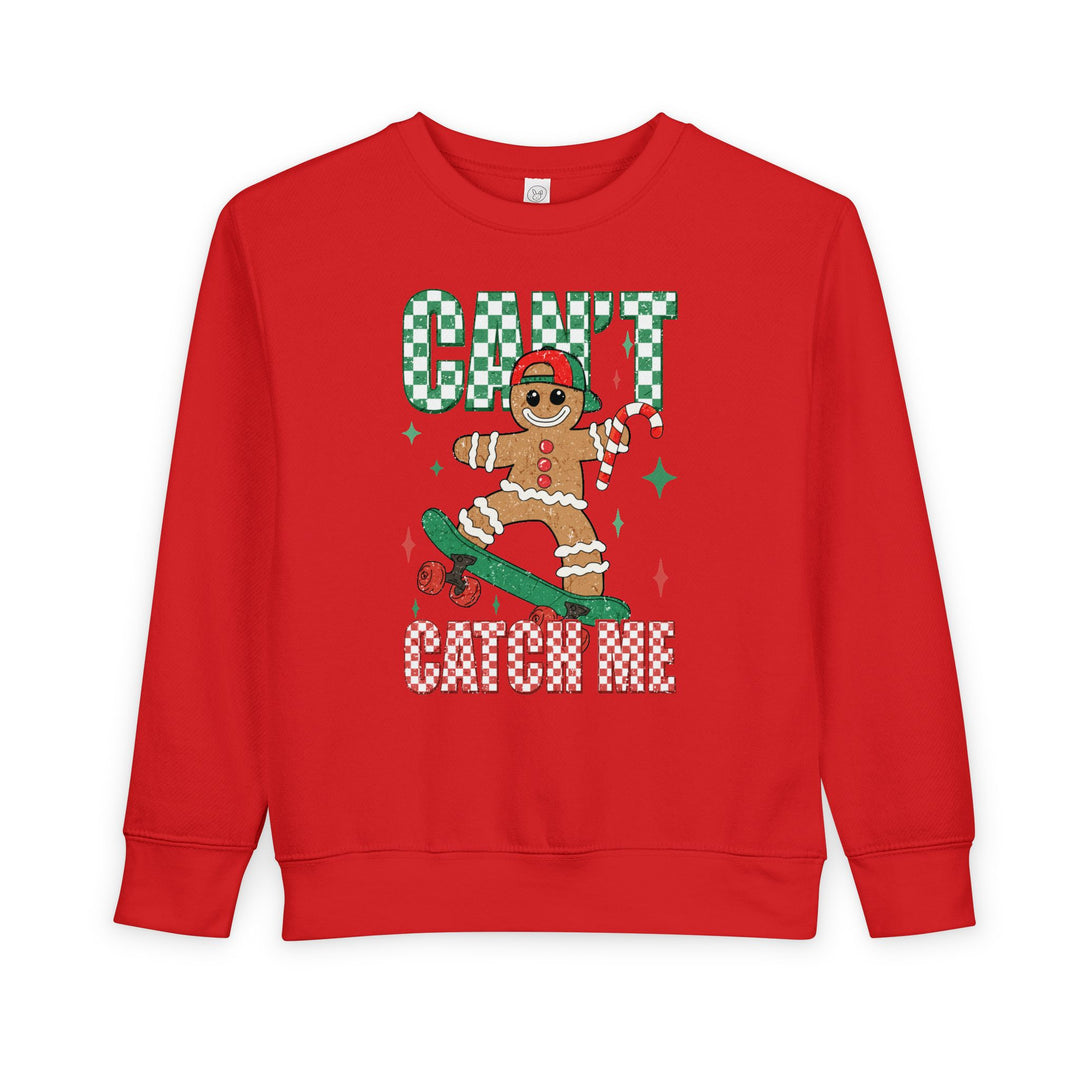 Can't Catch Me Toddler Crew: A red sweatshirt featuring a gingerbread skater with festive accents, ensuring warmth and comfort for toddlers.