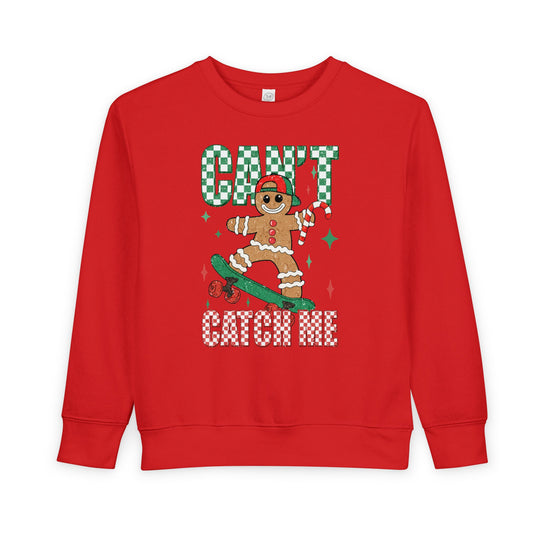 Can't Catch Me Toddler Crew: A red sweatshirt featuring a gingerbread skater with festive accents, ensuring warmth and comfort for toddlers.