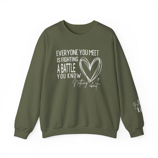 Olive-green crewneck sweatshirt, Fighting a Battle Crew, with white hand-lettered quote and heart graphic, plus Be Kind detail on sleeve. Unisex, durable, cozy.
