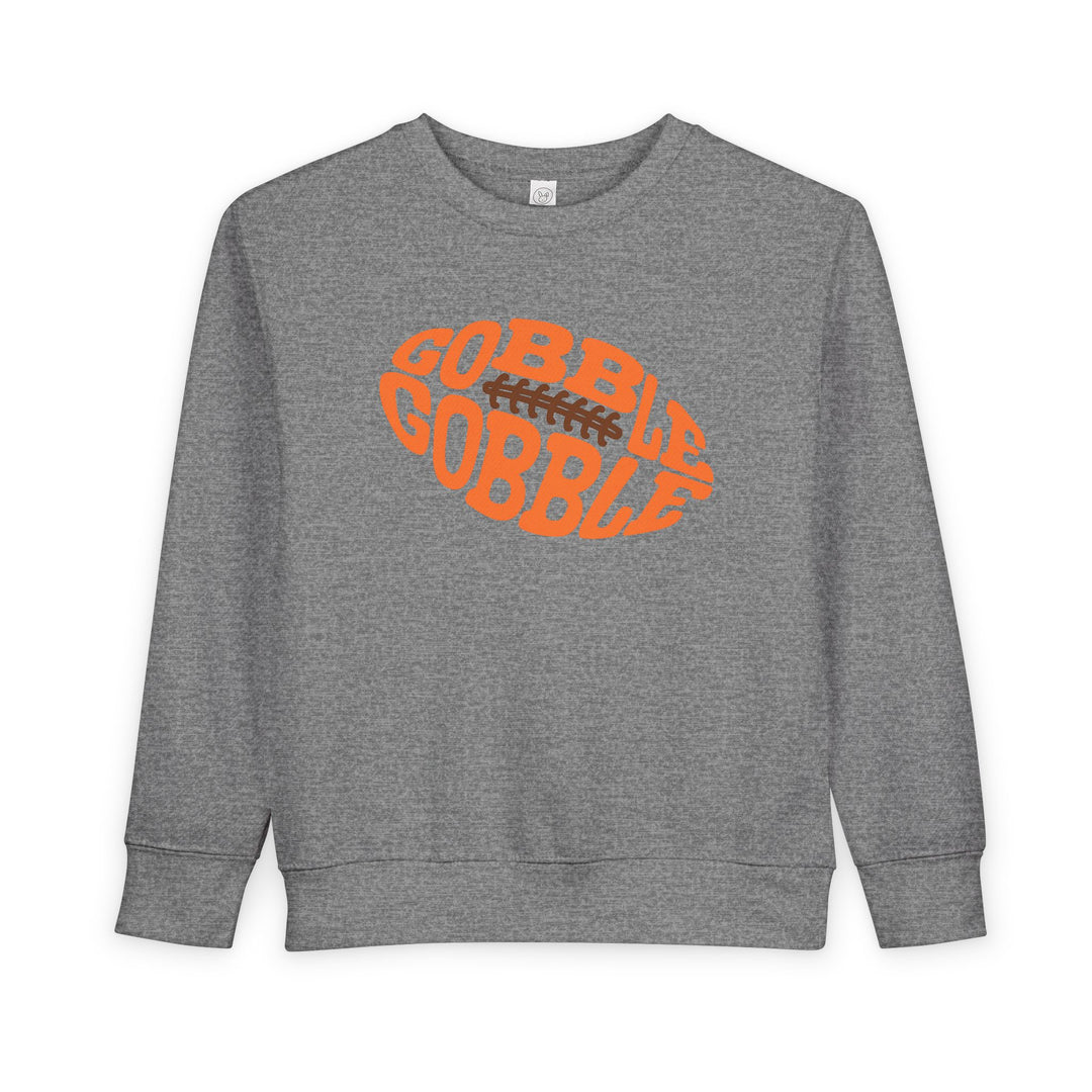 Heather-gray crewneck sweatshirt featuring GOBBLE GOBBLE in orange within a football graphic, ideal for toddlers seeking warmth and style.
