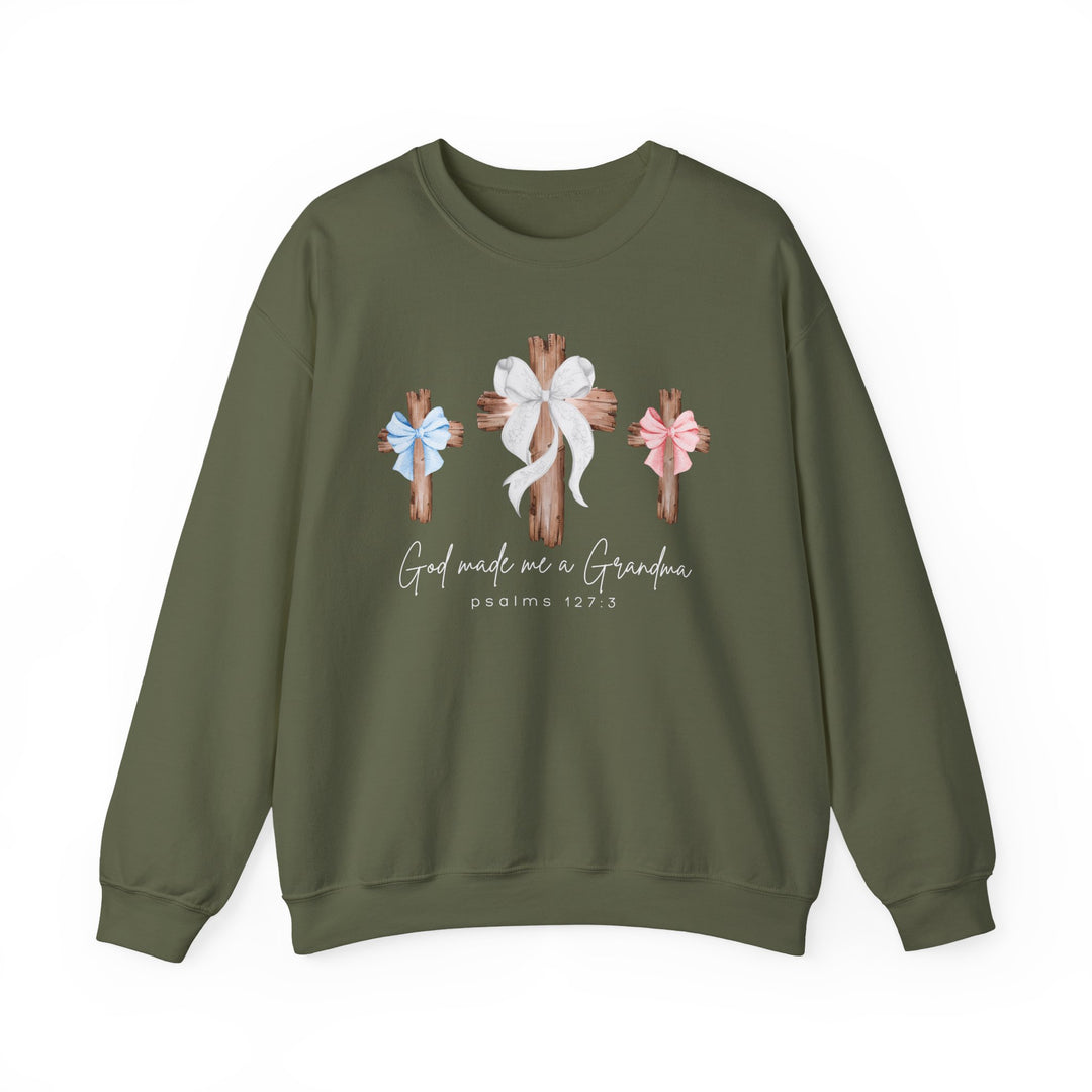 Olive-green crewneck sweatshirt featuring three wooden crosses with bows, script God made me a Grandma, and Psalms 127:3. Comfortable blend, loose fit.
