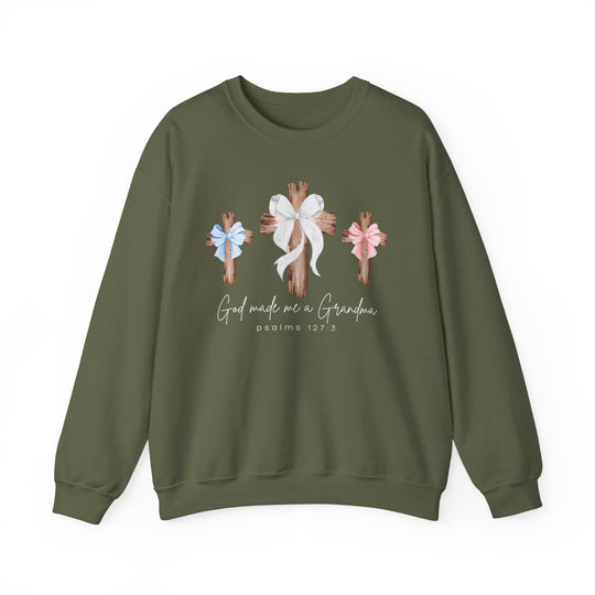 Olive-green crewneck sweatshirt featuring three wooden crosses with bows, script God made me a Grandma, and Psalms 127:3. Comfortable blend, loose fit.