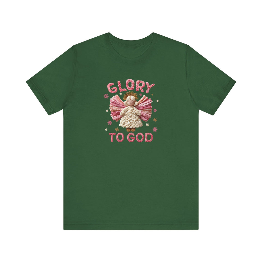 Forest-green Glory to God Tee featuring a yarn-style angel with pink wings, a creamy white dress, golden halo, surrounded by stars and snowflakes.