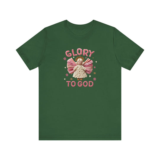 Forest-green Glory to God Tee featuring a yarn-style angel with pink wings, a creamy white dress, golden halo, surrounded by stars and snowflakes.