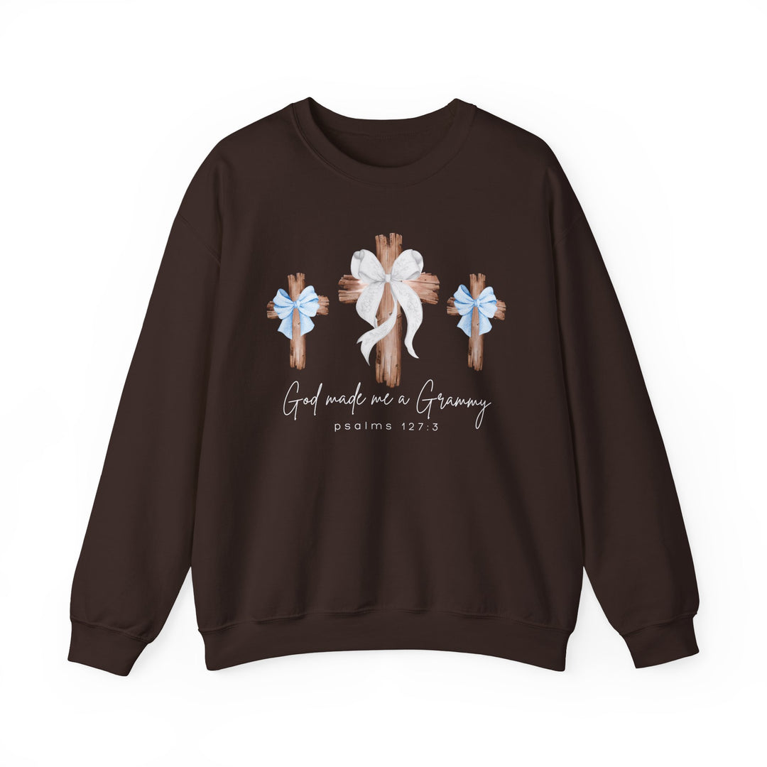 Dark brown crewneck sweatshirt featuring God Made Me Boy Grammy graphic with stylized wooden crosses and scriptural reference, offering comfort and a unique design.