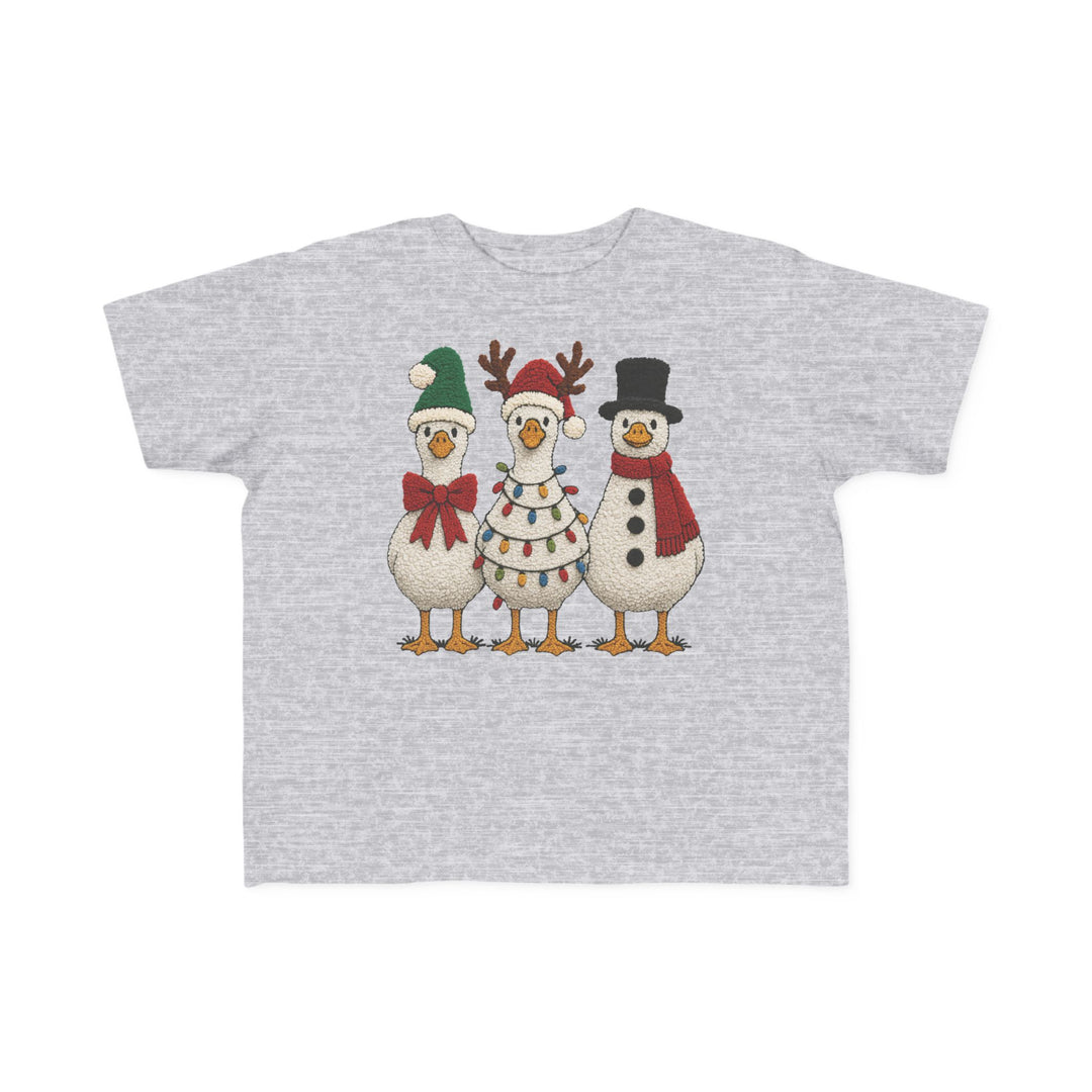 Christmas Ducks Toddler Tee featuring cartoon geese in festive attire: Santa hat, reindeer antlers, and snowman outfit. Soft cotton, perfect for toddlers.