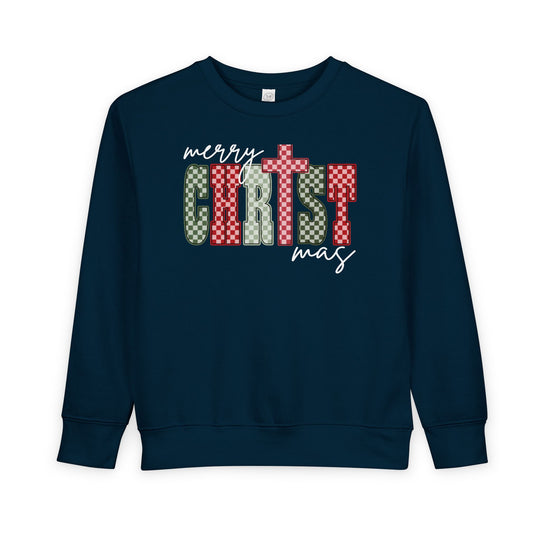 Navy-blue Christmas Toddler Crew sweatshirt with festive “Merry CHRISTmas” design featuring checkerboard letters and cross detail; cozy, soft fleece blend for toddlers.