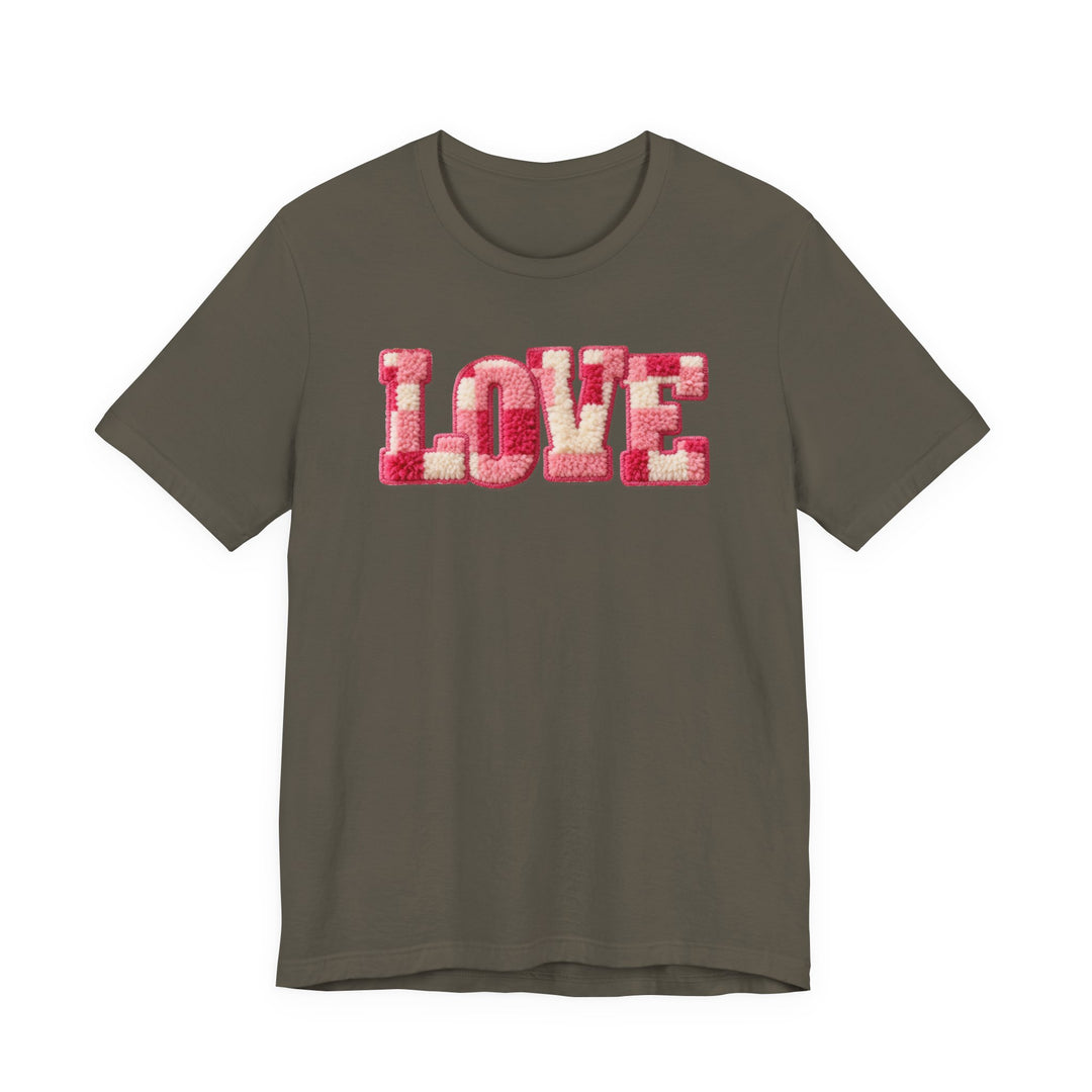 Love Tee featuring LOVE in pink and cream tufted yarn on olive green cotton. Unisex fit with ribbed collars and durable side seams for lasting wear.