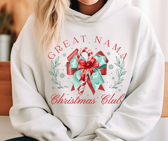 Person wearing a white Great Mama Christmas Club hoodie featuring a candy cane with a bow, holly, snowflakes, and stars, showcasing a festive design.
