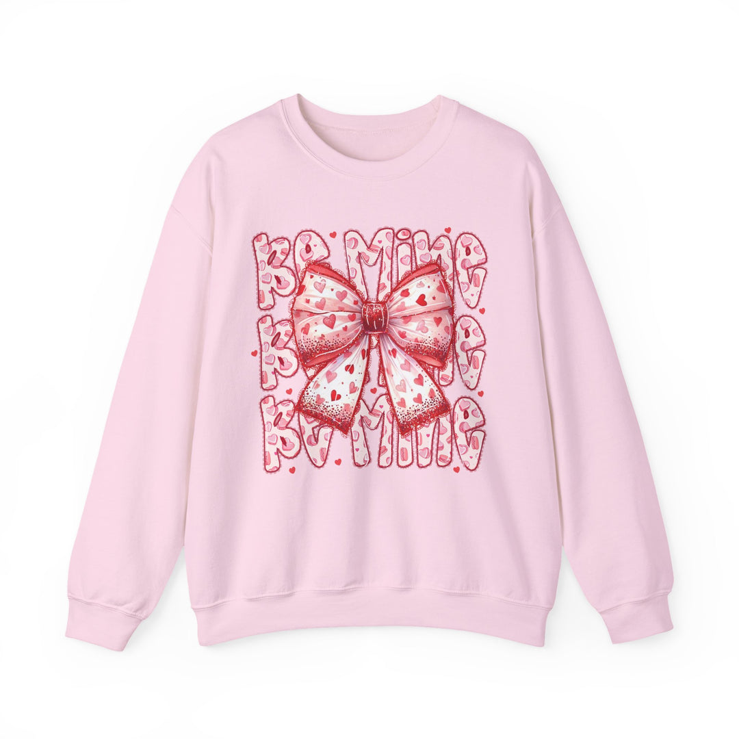 Be Mine Crew sweatshirt with a large red and pink heart-patterned bow and “BE MINE” text, designed for comfort with a polyester-cotton blend.