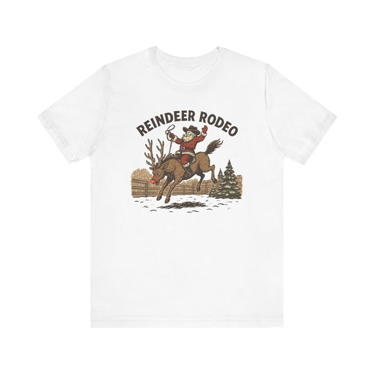 Reindeer Rodeo Tee featuring Santa as a rodeo cowboy on a bucking reindeer, perfect for adding humor to your Christmas wardrobe.