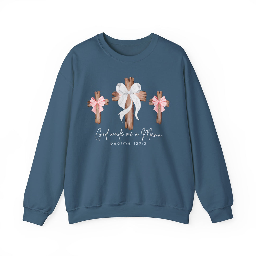 Slate-blue crewneck sweatshirt featuring three wooden crosses with bows and the text “God made me a Mama,” referencing Psalms 127:3.